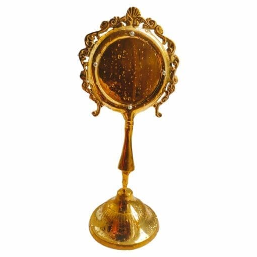 Snan Darpan, a brass mirror for Jagannath Puja. Used for symbolic cleansing of deities during daily rituals.