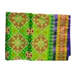 A skilled artisan weaving a Light Green Silk Pata on a loom, emphasizing the traditional craftsmanship behind the product.