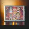 Jagannath and siblings photo frame placed on a puja altar, enhancing the sacred space and inviting blessings.