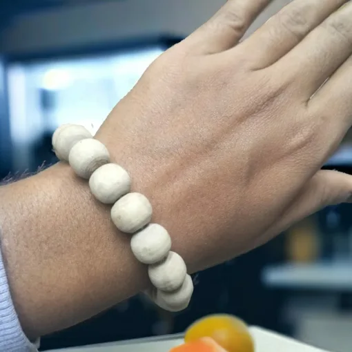 Close-up of the Tulasi wood bracelet, showcasing the natural beauty and smooth texture of the beads.