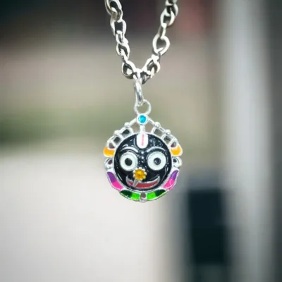 Person wearing the silver Jagannath locket with Nila Chakra, feeling a deeper connection to their faith.