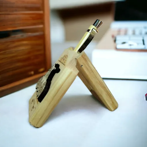 Handcrafted wooden pen stand with a pen, measuring 5 inches in height and 2 inches in width.