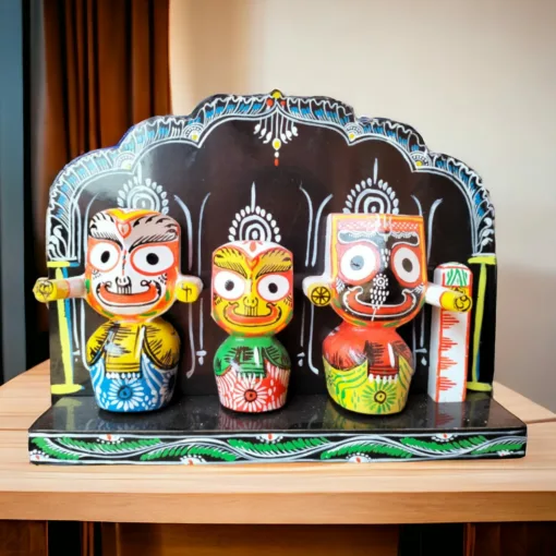 Shri Jagannath, Balabhadra, and Subhadra murtis with Singhasan, displayed with a Puja kit and offerings.