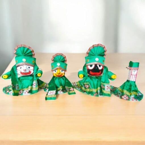 Lord Jagannath, Balabhadra, and Subhadra adorned in green silk pata dresses and Mukut.